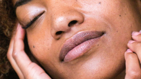 Closeup of a woman touching her face